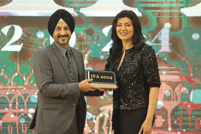 Dr Sandeep Anand holding the IFA 2024 award on stage