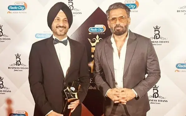 Dr Sandeep Anand with the Business Titans trophy on the red carpet