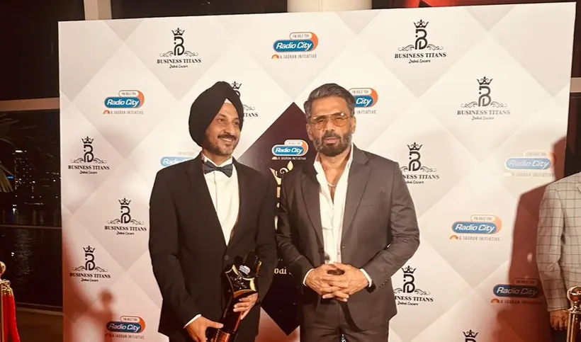 Dr Sandeep Anand with the trophy at the Business Titans media wall